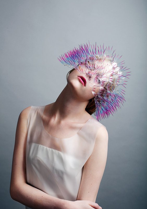 Person wearing spikes pink and purple sequin headpiece